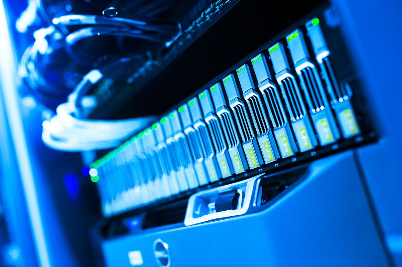 A detailed view of a blue lit computer server rack in a data center showcasing technology and hardware.